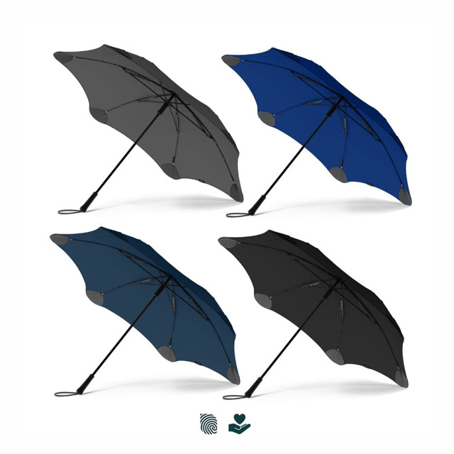 A collection of four BLUNT Exec Umbrellas in grey, navy, dark blue, and black, featuring a logo on each.