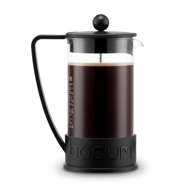 A French press in black and clear glass with a black handle, holding dark brewed coffee. It features a logo on the base.