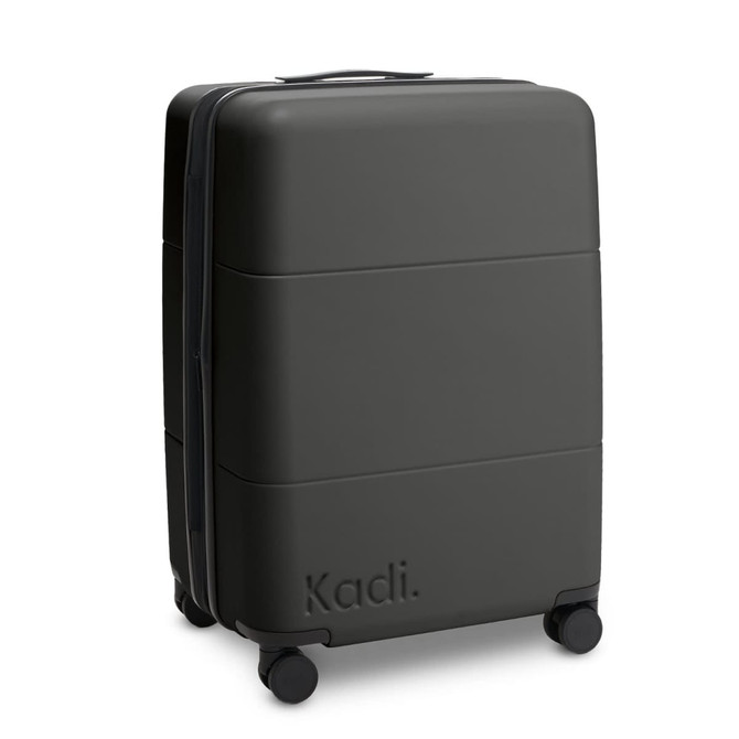 A medium suitcase in black with a textured surface and four wheels, featuring a logo.
