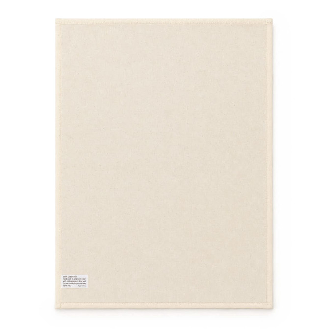 A large cream cotton tea towel featuring a plain design and a small label in one corner.