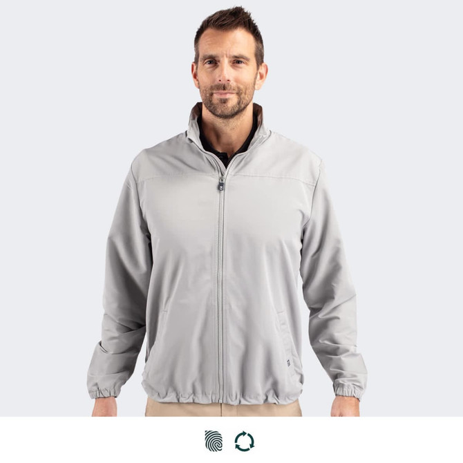 A full zip jacket in light grey worn by a male model, featuring a collar and elastic cuffs. It has a logo.