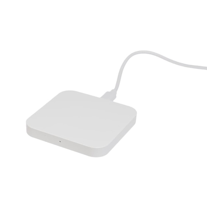 A sleek, square wireless charger in white with a connected cable.
