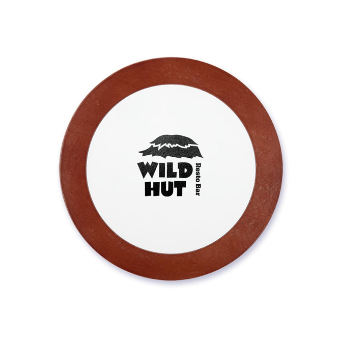 A round coaster with a white centre and a brown rim, featuring the logo of "Wild Hut Resto Bar."