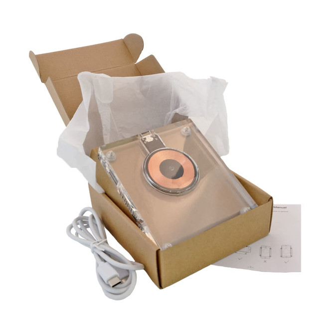 A crystal wireless charger in a box, featuring a copper charging pad, USB cable, and tissue paper.