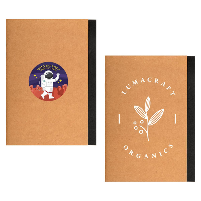 A brown A5 notebook with a space-themed sticker on one side and a logo on the other. Features a black spine.