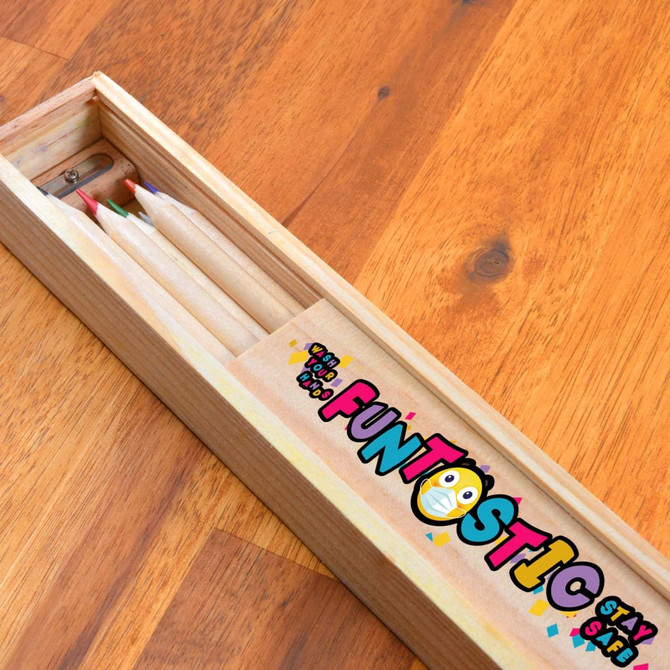 A wooden pencil case containing several coloured pencils, featuring a brand logo and a fun design.
