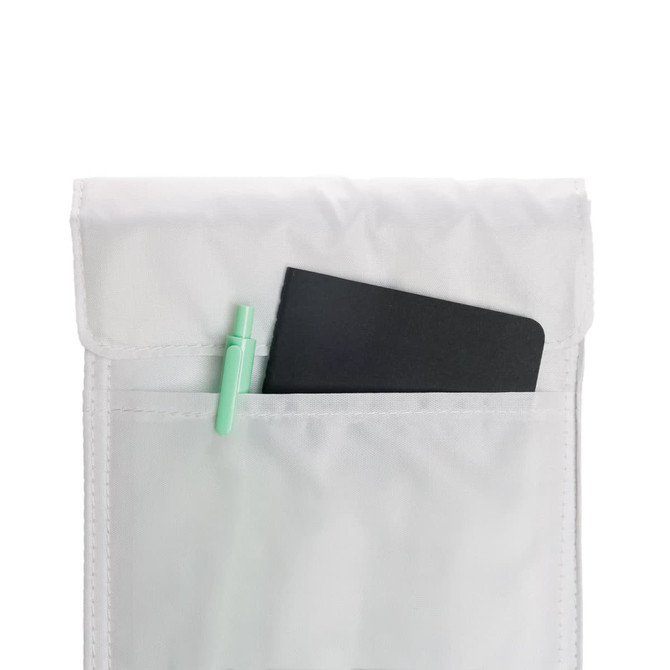 A white cooler lunch bag with a black notebook and a green pen peeking out of the pocket.