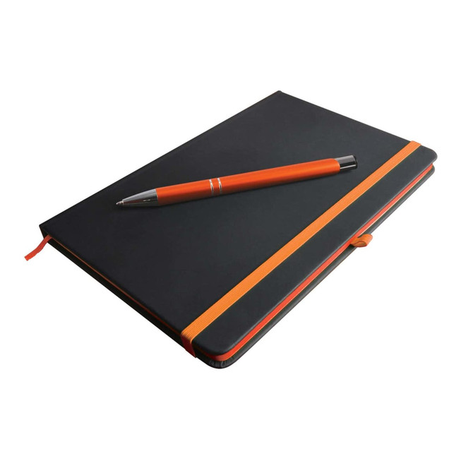 A black notebook with an orange elastic band and an orange pen resting on top. The notebook has a logo.