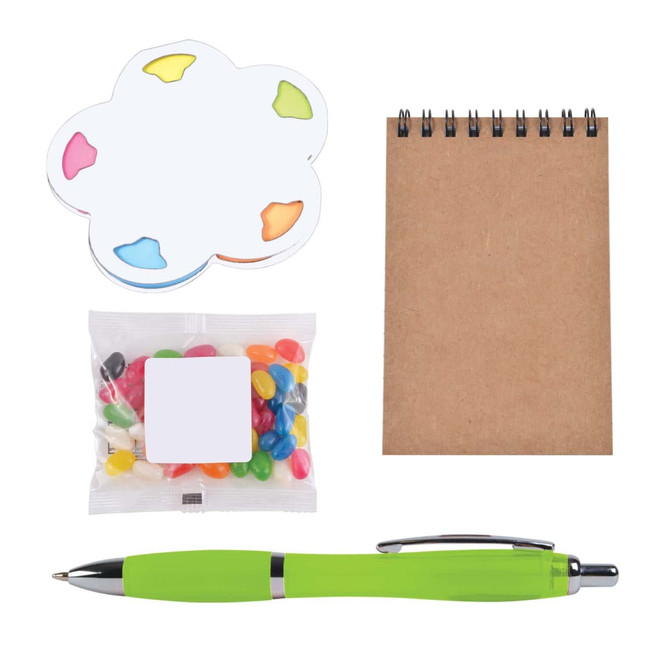 A colorful notepad in the shape of a flower, a small bag of jelly beans, a blank notepad, and a green pen.