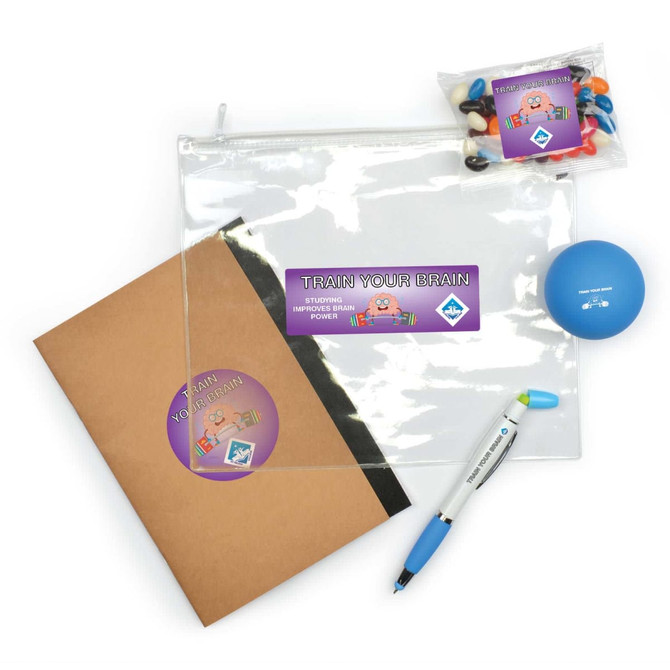 A clear zipper pouch, a brown notebook, a blue stress ball, and a pen, along with a packet of colorful candies.