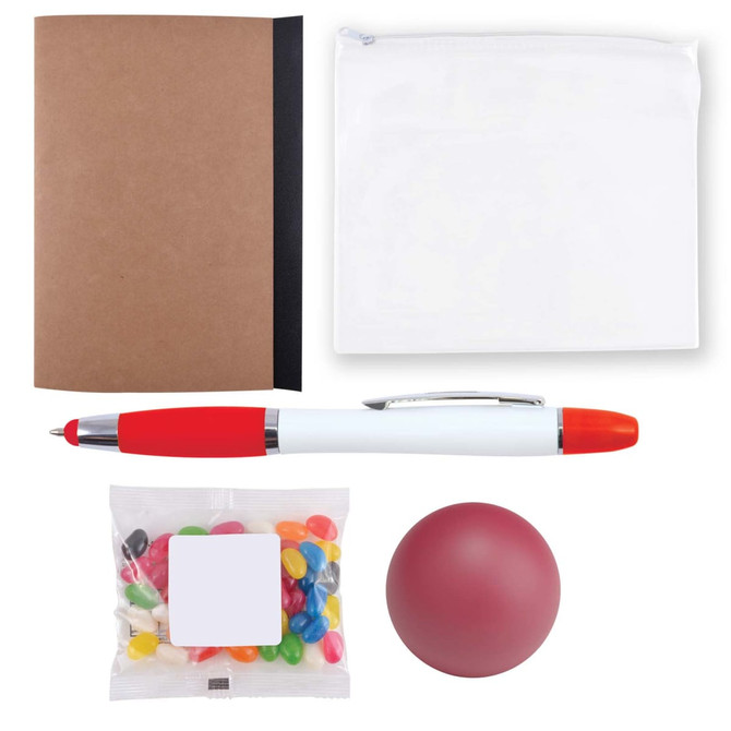 A brown notebook, a clear pouch, a red and white pen, a red stress ball, and a bag of colorful jelly beans.
