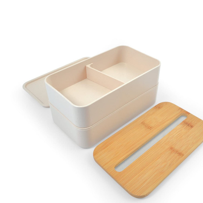 A cream-colored lunch box with a bamboo lid and divided interior, designed for eco-friendly use.