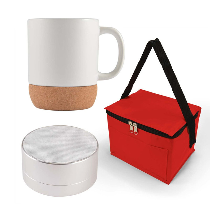 An espresso coffee mug with a cork bottom, a compact silver speaker, and a red carrying bag are displayed together.