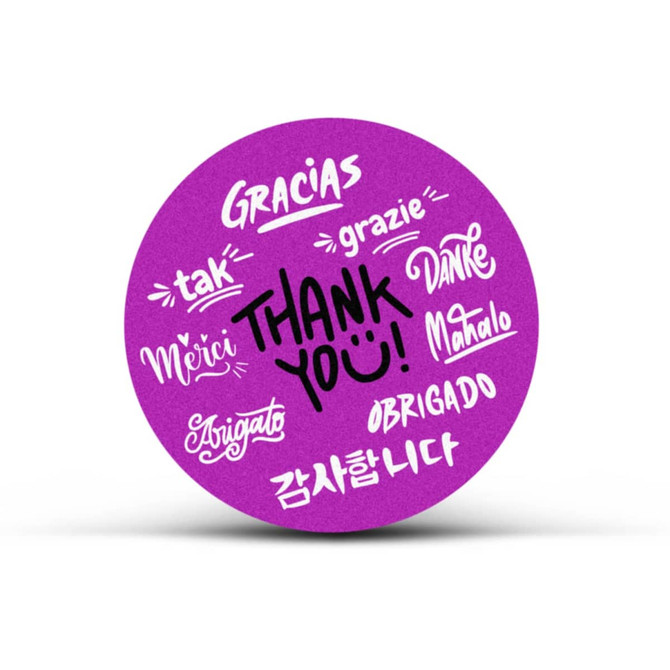 A circular purple sticker featuring the phrase "Thank You" and various translations in different languages.