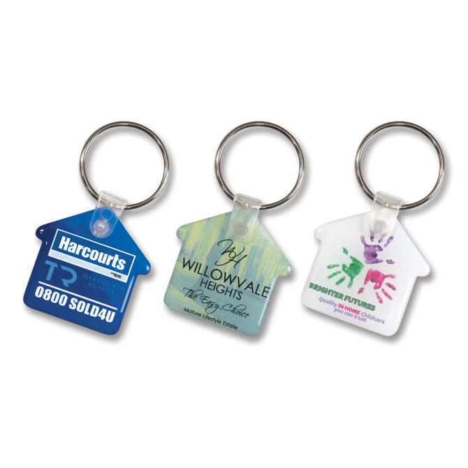 Three house-shaped key rings in blue, green, and white, each features a logo and colourful designs.