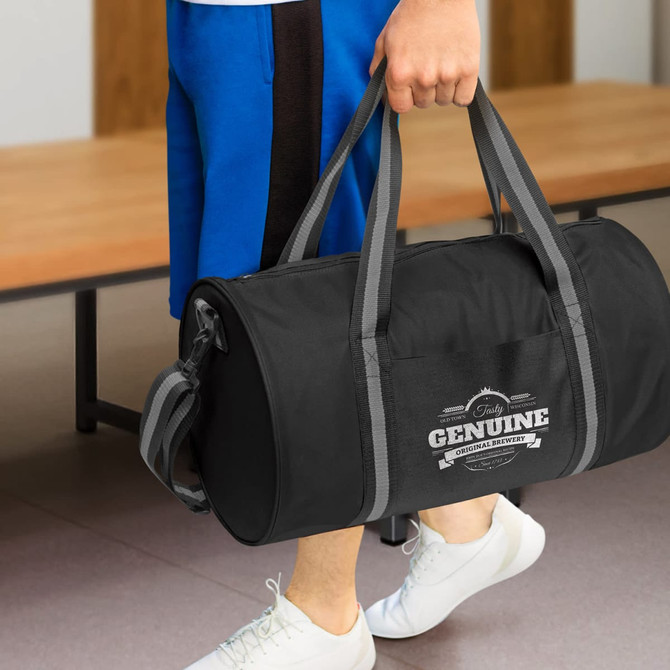 A black duffle bag with gray straps featuring "Genuine" branding is being held by a person.