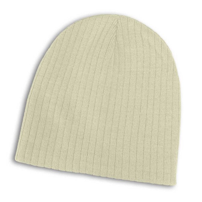 A Nebraska Cable Knit Beanie in a light color, featuring a ribbed texture.