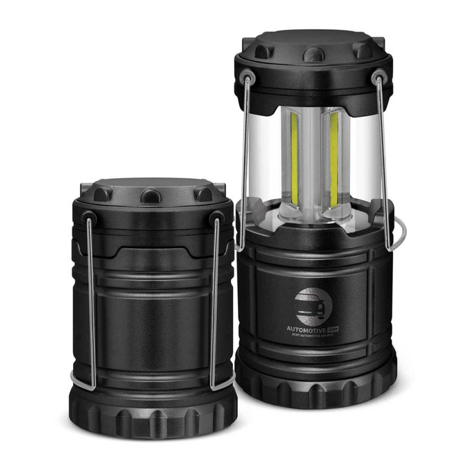 A black COB lantern with a transparent casing and two adjustable handles, showcasing its compact design.