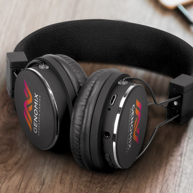 A pair of black Bluetooth headphones with a logo on the ear cups, featuring cushioned ear pads and a sleek design.