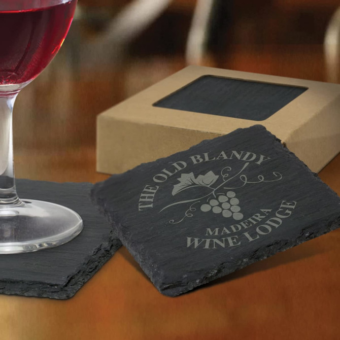 A set of four slate coasters featuring a wine lodge design and packaging.