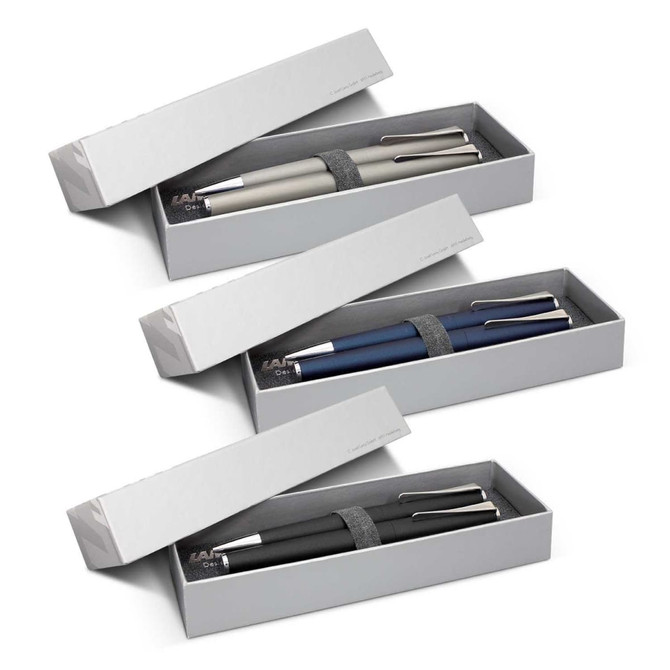 A pen set featuring three metal pens in grey, blue, and black, packaged in a sleek grey box with a logo.