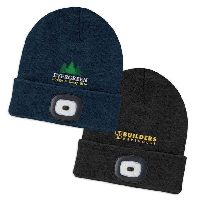 A navy beanie with a headlamp and logo, alongside a black beanie with a headlamp and another logo.