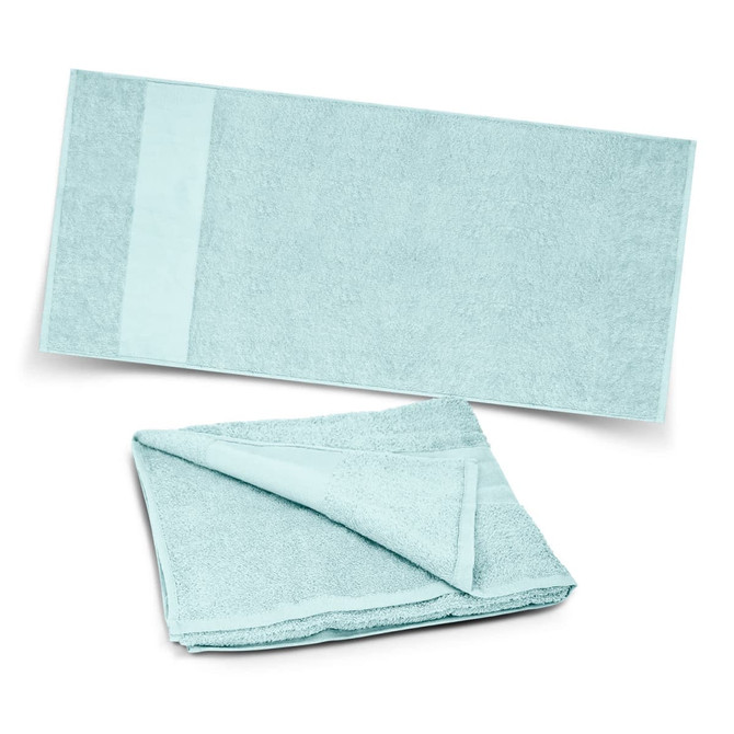 A soft, light blue beach towel displayed flat and partially folded, featuring a textured surface and a smooth edge.