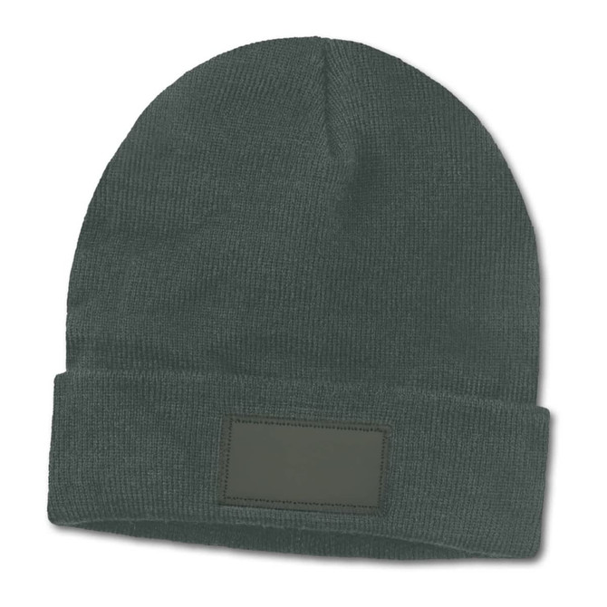 A green beanie with a folded cuff and a blank patch for customization.
