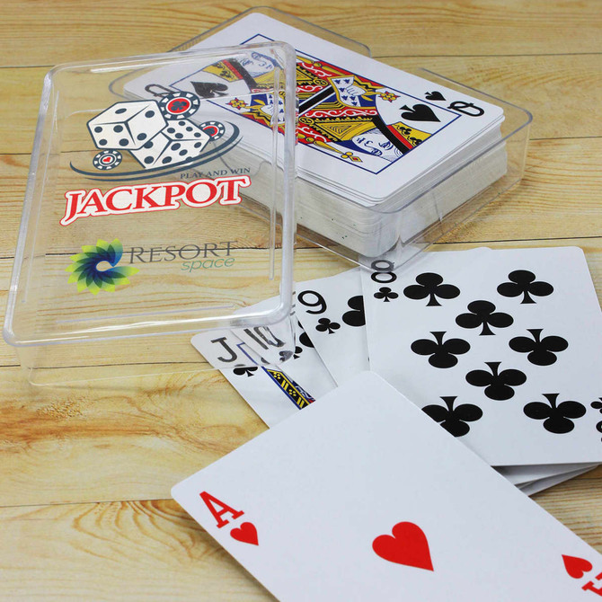 A clear plastic case holds a deck of playing cards featuring red and black designs with a logo.