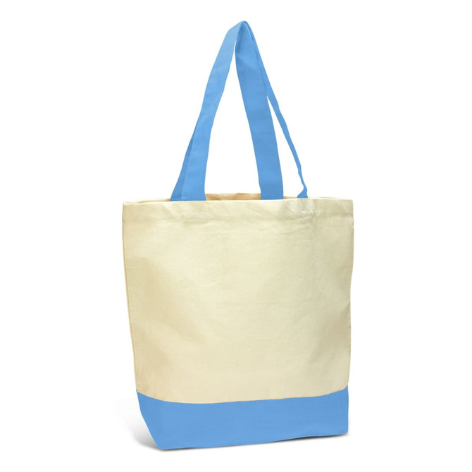 A canvas tote bag featuring a cream body and light blue bottom, complete with long blue handles and a logo.