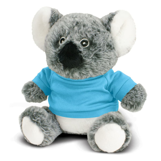 A grey koala plush toy wearing a blue shirt, sitting with a soft white belly and large ears. It has a small branding logo.