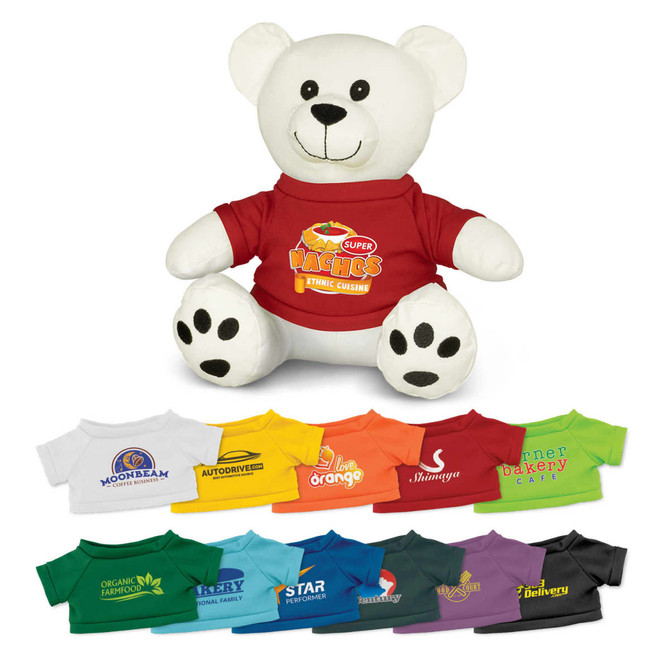 A plush white bear toy wearing a red shirt, surrounded by various coloured t-shirts in different styles.