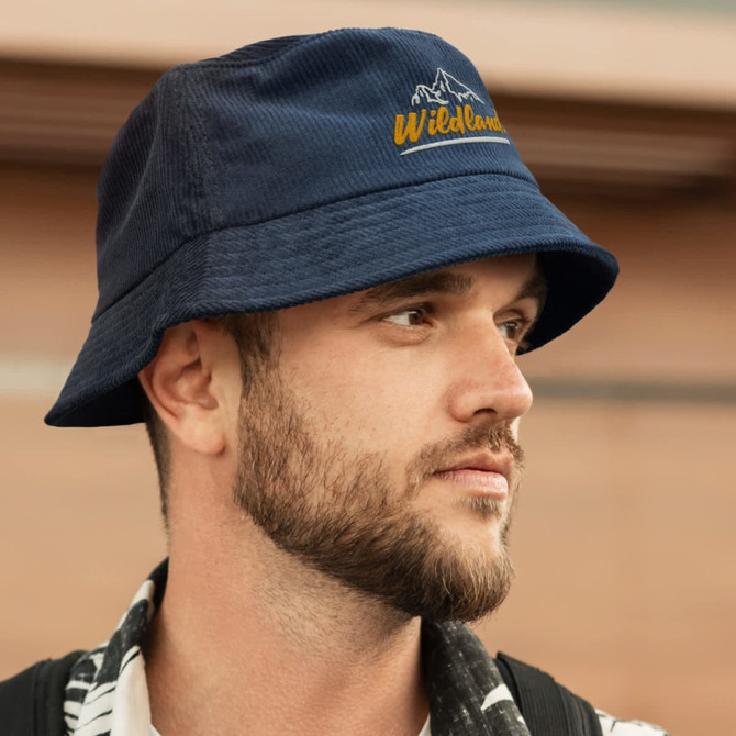 A navy corduroy bucket hat with an embroidered logo, featuring a wide brim and a casual style.