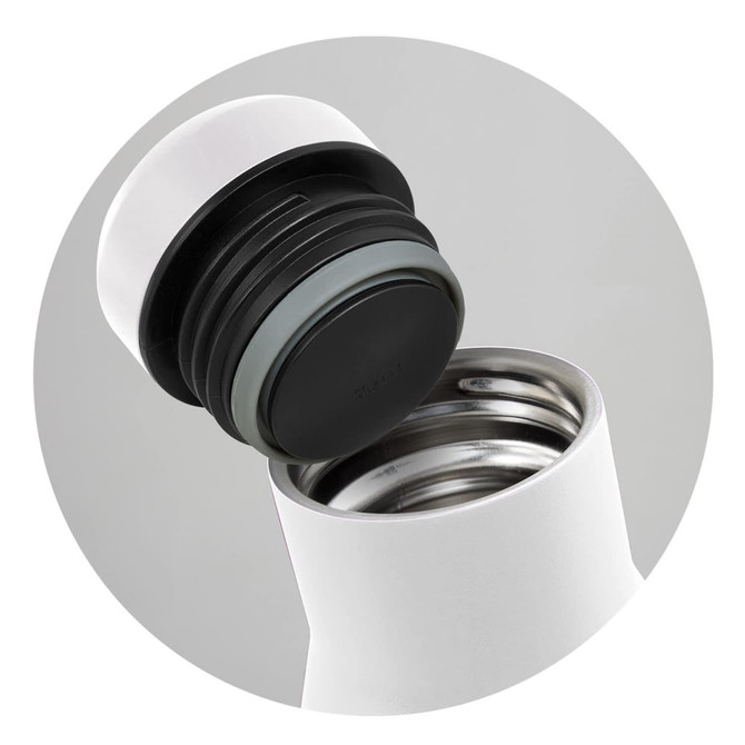 A drink bottle in white with a black lid, featuring a stainless steel interior and a step-up cap design.