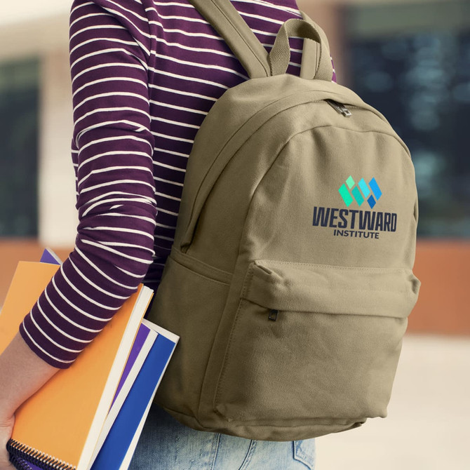A khaki canvas backpack with a logo, being held by a person in a striped shirt, alongside some notebooks.