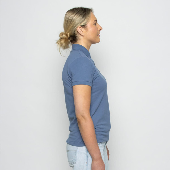 A side view of a blue women's polo shirt, featuring a collar and short sleeves, with a logo on the chest.