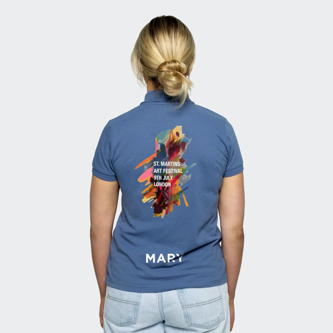 A women's polo shirt in blue featuring a vibrant abstract design on the back and a logo.