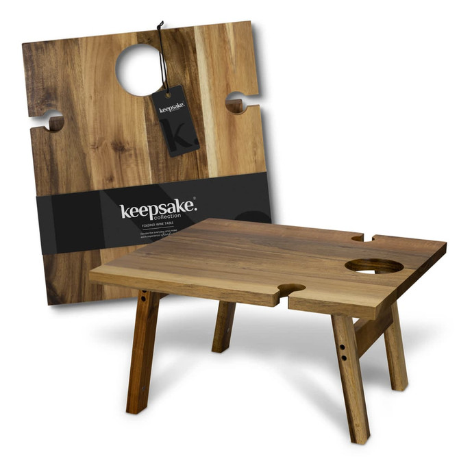 A wooden folding wine table with a circular cutout, featuring light and dark brown tones, and a tag with branding.