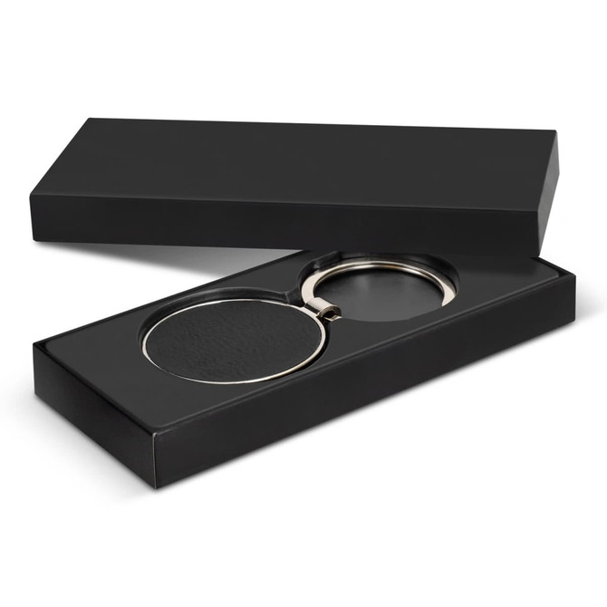 A round black key ring with a silver metal loop presented in a black box.