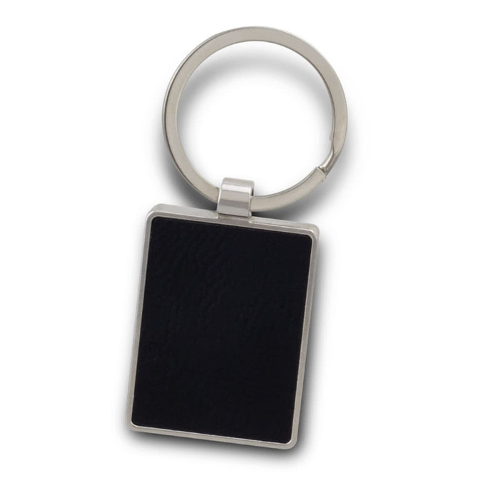 A rectangular key ring in silver with a black textured surface and a circular keyring attachment.
