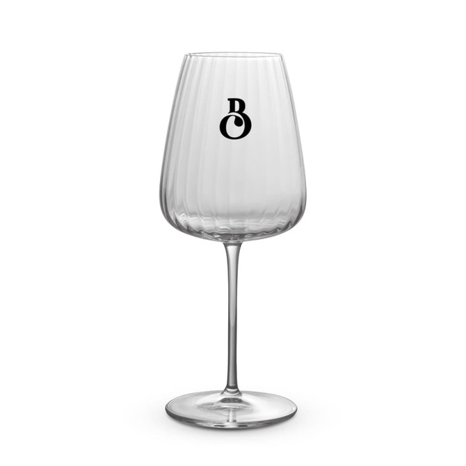 A clear, ribbed Chardonnay glass with a tall stem, featuring a subtle logo.