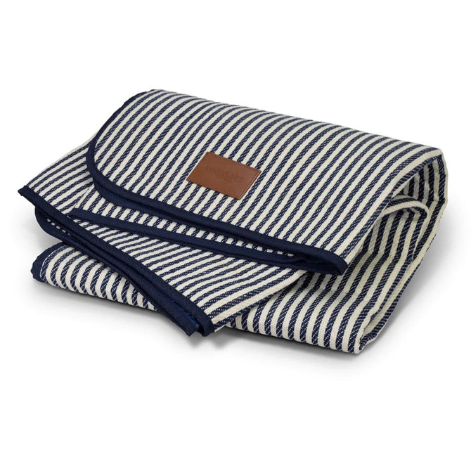 A folded picnic blanket with a navy and white striped design and a leather tag, showcasing a neat, compact appearance.