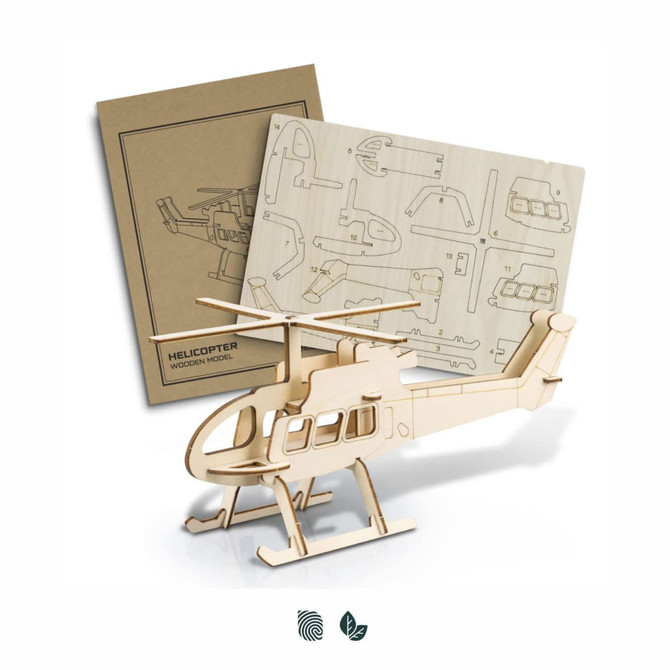 A wooden helicopter model in natural wood colour alongside instruction sheets for assembly.