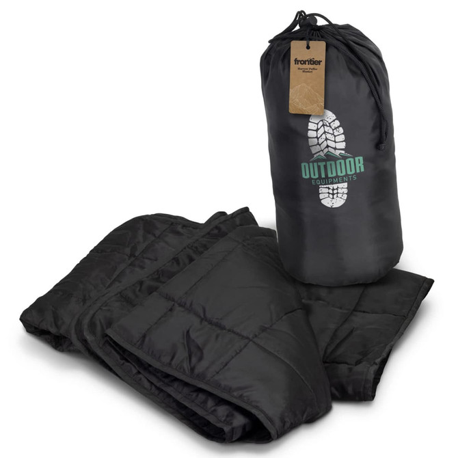 A black puffer blanket folded with a carrying bag, featuring a logo and a textured design.