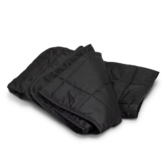 A black puffer blanket is neatly folded, showcasing its quilted texture and warm design. It has a branding logo.