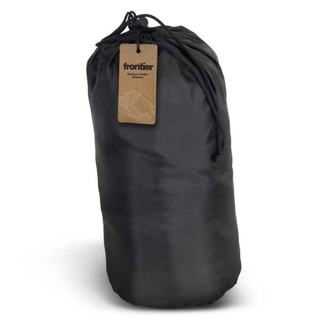 A black puffer blanket stored in a compact roll, with a drawstring closure and a tag attached.