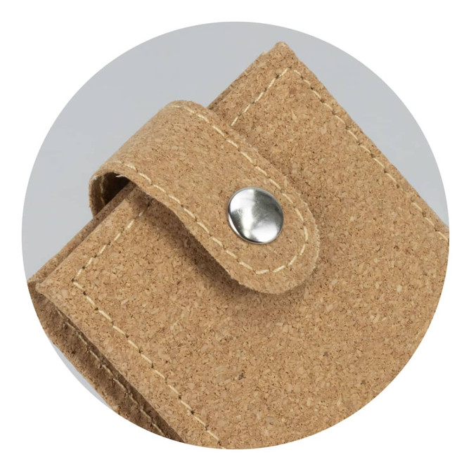 A cork manicure set with a snap closure, featuring a natural beige tone and textured finish. It has a logo.