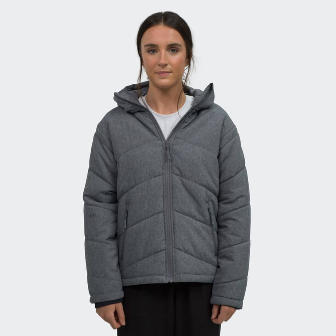 A grey puffer jacket with a hood worn by a model, featuring a quilted design and front zip.