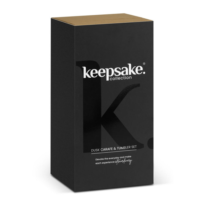A black and gold box containing the Keepsake Dusk Carafe and Tumbler Set, featuring a branding logo.