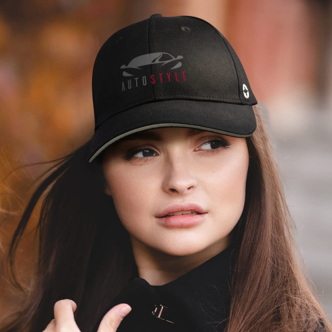 A black Swiss Peak 6 Panel Cap with a logo, worn by a person with long hair outdoors.